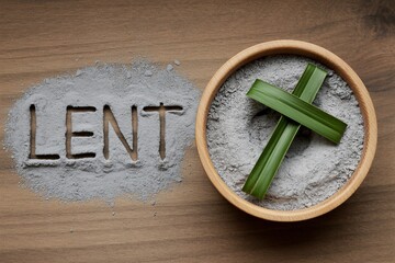 Lent season concept with cross made of palm leaves in ash bowl on wooden table for christian religious observance with faith