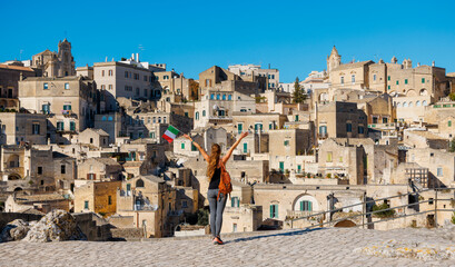Woman tourist enjoying panoramic view of Matera city in Italy.