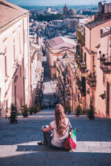 Woman tourist exploring a picturesque city in Sicily, Caltagirone