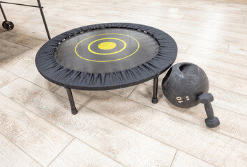 Mini trampoline and kettlebell on gym floo