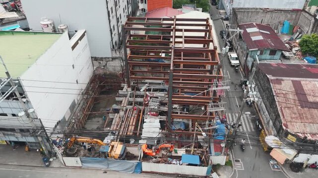 Construction site with backhoe and workers