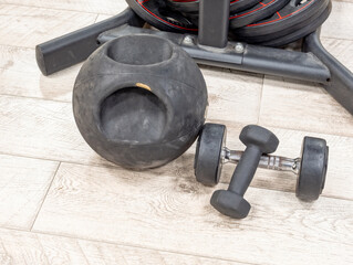 Kettlebell and dumbbells on gym floor close-up