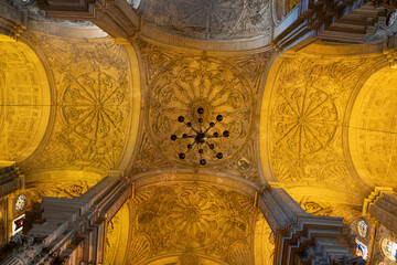Intricate ceiling design with ornate decorations and lighting.. Cathedral of Malaga, Spain