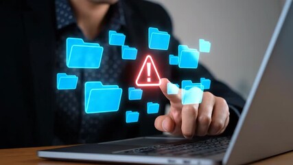 Businessman interacts with digital warning symbol on futuristic file management interface - Powered by Adobe