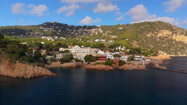 Beautiful aerial view moving towards the picturesque coastal town of fornells and aiguablava bay, nestled among green hills and rocky cliffs on the scenic costa brava in catalonia, spain