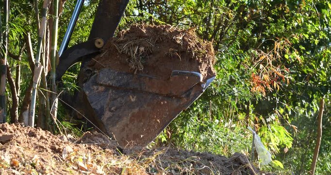 Excavator at Work: The excavator's mechanical arm digs into the earth, showcasing the power of construction and progress. Emphasizing the industrial process and the raw materials of nature.