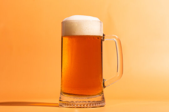 a glass of beer on a beige background