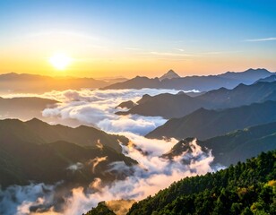 Panoramic view of mountains at sunrise, clouds enveloping them