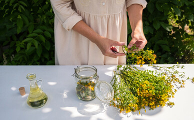 St. John's Wort Oil Recipe Step 6: Woman Filling Jar with Hypericum