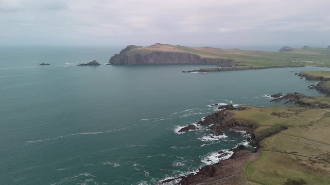 Scenic 4K aerial video of flying above spectacular Atlantic coastline, with picturesque rocks, cliffs and islands, Sybil head, Dingle Peninsula, Kerry, Ireland