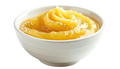 Close-up of a white bowl overflowing with a smooth, golden-yellow, semi-solid food