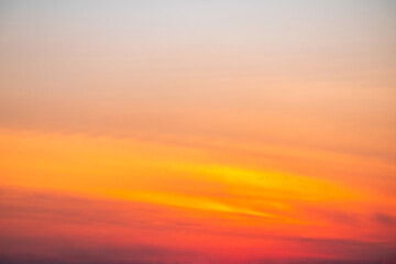 Sunset or sunrise sky with a vibrant gradient of orange, gold, and soft blue. Clear atmosphere with wispy clouds. Peaceful, natural light background. hope, freedom, new day and inspirational Concepts