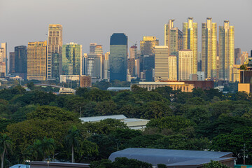 Modern office building and condominium with green tree Lumphini park sunset sky