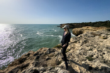  the Algarve coast in Portugal, is a stunning natural sea cave with a large, circular opening in...