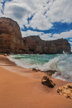 Golden cliffs and turquoise waters at Praia da Marinha, Algarve, Portugal.