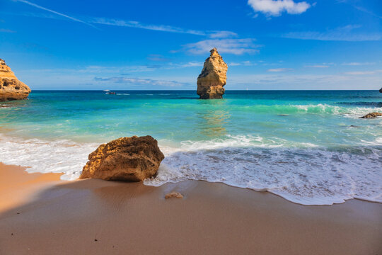 Golden cliffs and turquoise waters at Praia da Marinha, Algarve, Portugal.