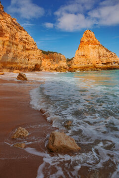Golden cliffs and turquoise waters at Praia da Marinha, Algarve, Portugal.