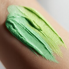 Intimate skin texture with a vibrant green cosmetic smear and hydration glow