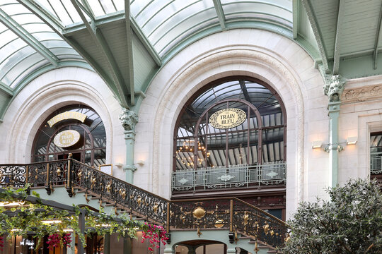 Paris, France, October 25, 2025 - Low angle view of the famous 1901 Gare de Lyon restaurant Le Train Bleu signs and entrance 