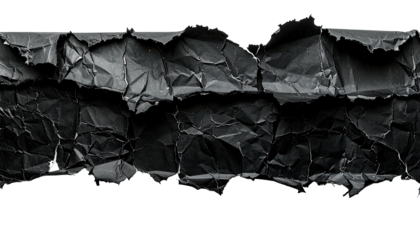 Close-up of ripped and crumpled black paper strips. Shadowed surface detail & texture revealed