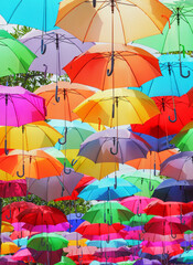 Vibrant Hanging Umbrellas Display. Lots of umbrellas coloring the sky.
