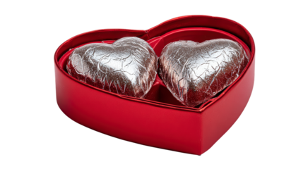 Red heart shape box with two chocolate candy wrapped in silver foil for valentine season present on celebrate love and sweet romantic moment