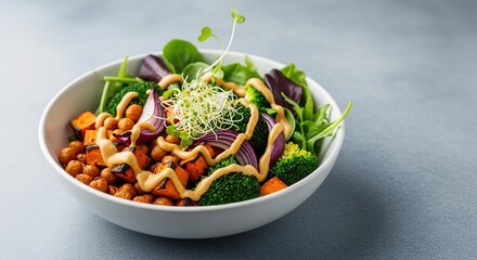 Healthy vegan salad bowl with roasted chickpeas and fresh greens.