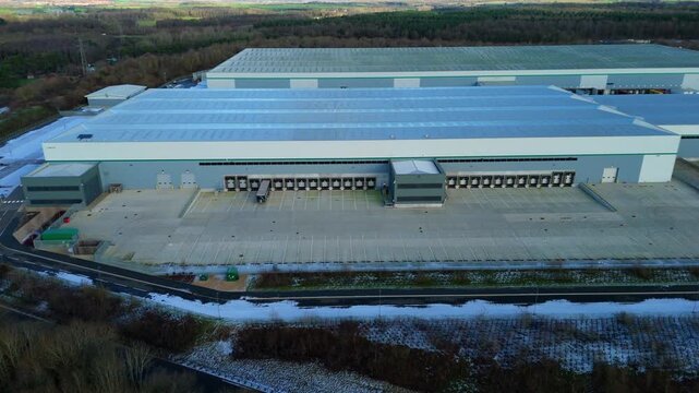 Aerial view of large industrial distribution centres with loading bays and vast concrete yards, Kettering, Kettering, United Kingdom.