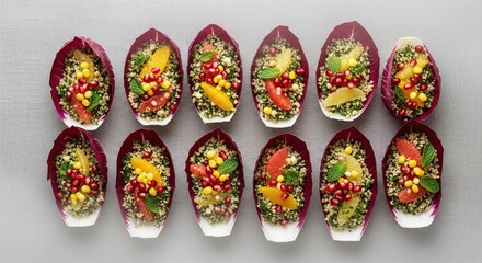 Colorful Radicchio Cups Filled with Quinoa Salad, Garnished with Pomegranate Seeds.