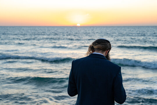 Jew perform the Tashlich - Jewish prayer ceremony for Rosh Hashanah on the beach of Tel Aviv