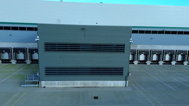Aerial view of loading bays and industrial units with grey and white facades in the distribution centre, Kettering, Kettering, United Kingdom.