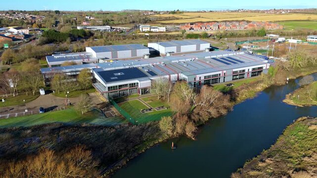 Aerial view of the Nene Business Centre, where modern architecture meets the tranquil riverfront, creating a harmonious blend of industry and nature, Irthlingborough, United Kingdom.