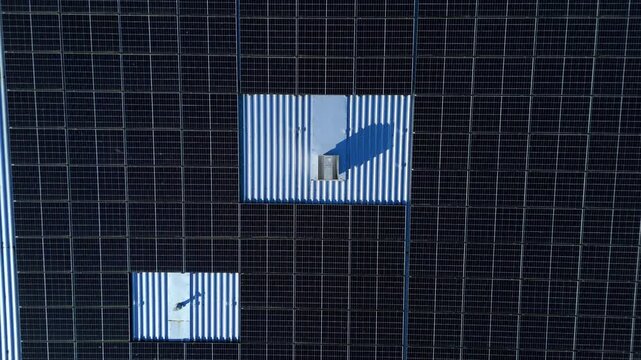 Aerial view of the dark solar panels on the roof of Nene Business centre, contrasting with the surrounding landscape, Irthlingborough, United Kingdom.