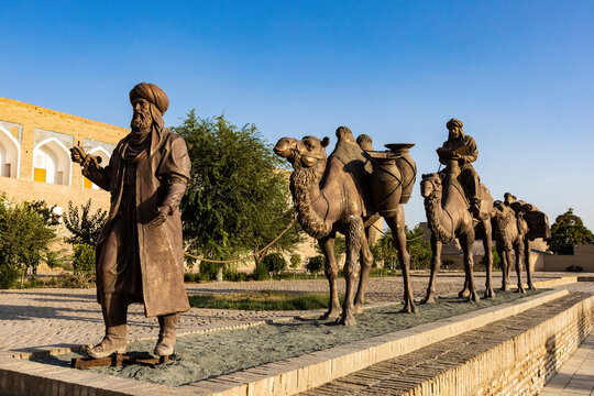 Khiva, Uzbekistan - 11 August 2025:   monument and in the backgroud Madrasa Mohammed Amin Khan
