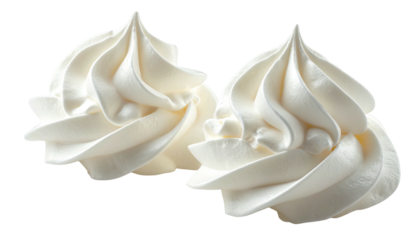 Close-up of two elegantly swirled dollops of creamy white dessert topping