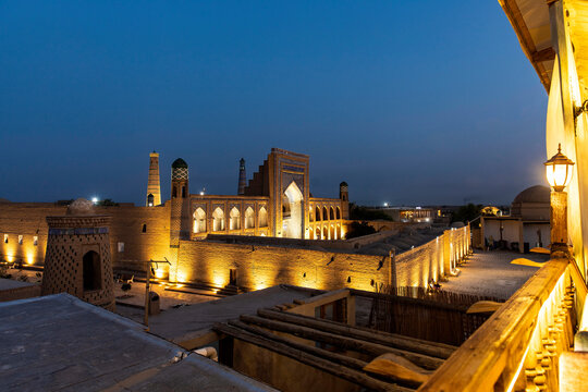 Khiva, Uzbekistan - 11 August 2025: a street in the center at night and Madrasa Mohammed Rahim Khan