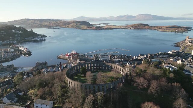 Stunning drone shot of Oban and the nearby isles on a winter sunny day. Drone flying forward slowly,
