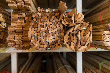 Top view of wood planks stacked in organized pattern inside woodworking supplier shop, interior construction wood materials prepared for furniture manufacturing and small business inventory management