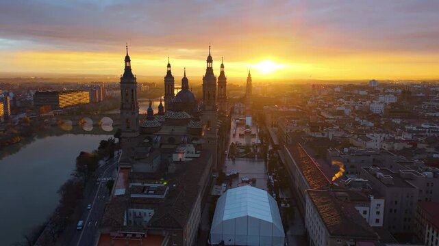 Aerial View Capturing Sunset Glow Illuminating Cathedral Domes And Tranquil River Reflections. Zaragoza. Spain 