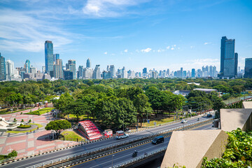 City road with modern office building green tree public park