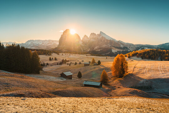 Sunrise over Alpe di Suisi with Sassolungo and Sassopiatto mountian peak on grass hill in Dolomites