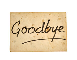 Goodbye handwritten text on vintage paper card with aged grunge texture farewell message close up on isolated background