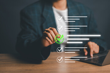 Businessperson using a digital checklist on a laptop, symbolizing productivity and task management in a modern office environment.