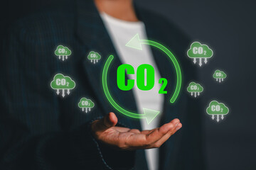 Visual representation of CO2 emission reduction with green symbols and arrows, highlighting sustainable energy concepts.