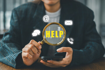 Businesswoman holding a magnifying glass over help icons, symbolizing communication and support in a digital environment.