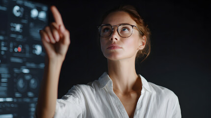 Woman in glasses interacting with a futuristic holographic display showing data charts