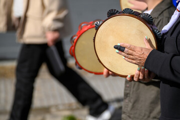 Playing traditional tambourine in Spanish parade. The Concept of Folklore.