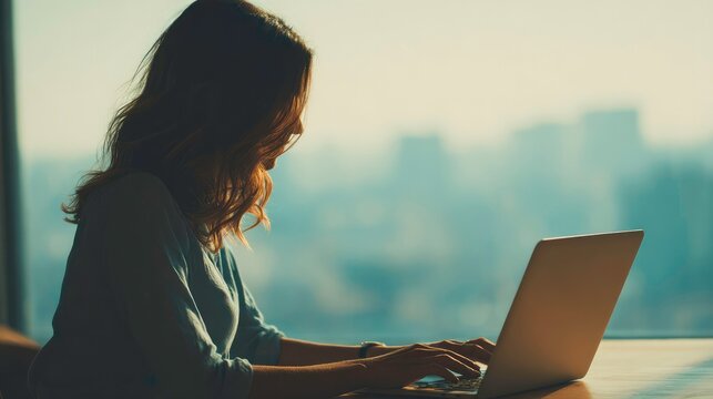 young business woman or student on laptop computer at the desk with city view. Manager businesswoman or female student 
