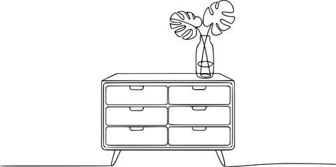 Minimalist of a dresser with monstera leaves in a glass vase furniture plant
