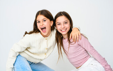 Two cute and Young pre teen girl on studio white